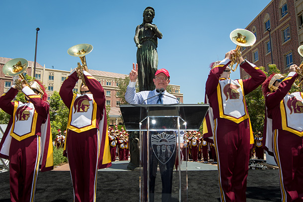 USC President C. L. Max Nikias shows his Victory sign as Trojan Marching Band members play “Conquest” during the grand opening of the USC Village, held Aug. 17 on the University Park Campus.