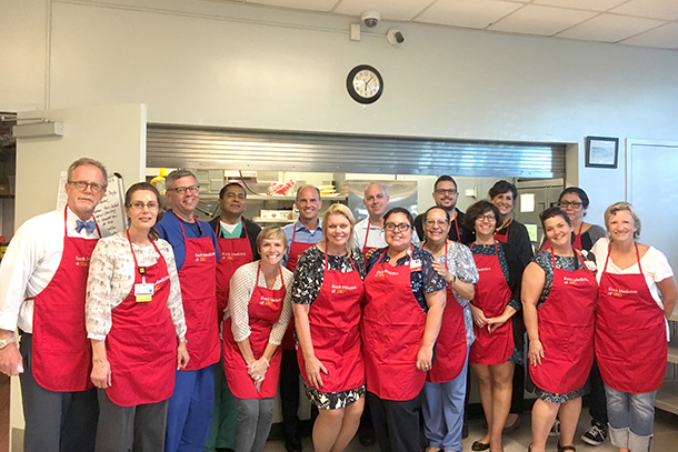 Leaders from Keck Medicine of USC volunteer to serve meals during a recent dinner at Dolores Mission.