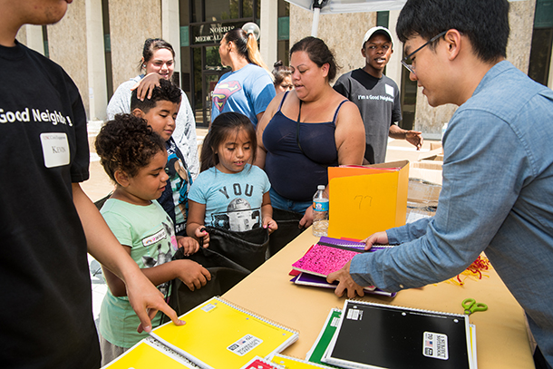 Children pick up notebooks during a School Supply Giveaway sponsored by USC Civic Engagement and held Aug. 26, 2017, on the Health Sciences Campus.