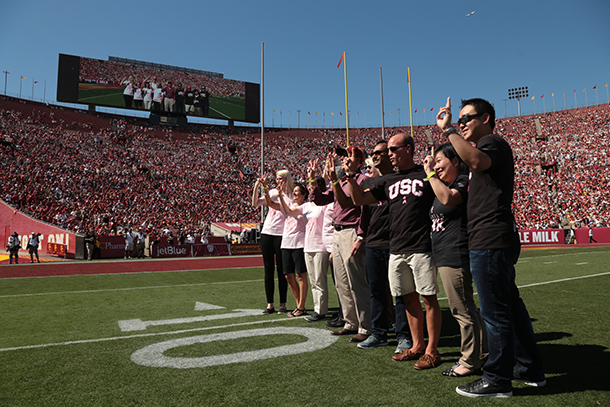 A group of Keck Medicine of USC leaders, physicians and patients are recognized on the field during the Oct. 7 football game at the Los Angeles Memorial Coliseum.