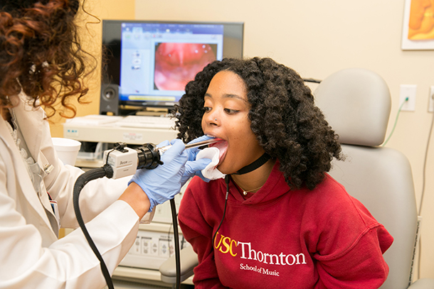 Soprano Vivian Stover, an undergraduate student of the USC Thornton Vocal Arts program, vocalizes while a Keck Medicine of USC laryngologist records a live video feed of Stover’s vocal cords.