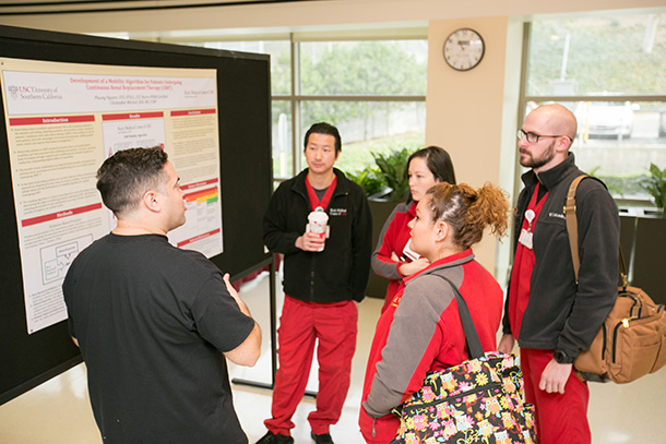 Keck Medicine of USC employees listen to a presentation during the Interprofessional Research Poster Symposium.
