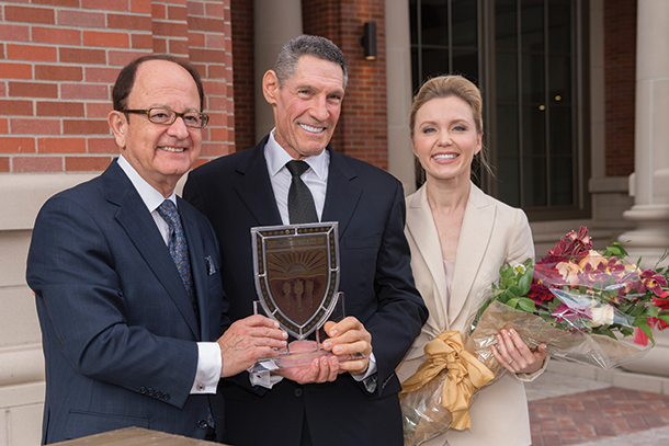 USC President C. L. Max Nikias hands Gary and Alya Michelson a plaque to commemorate the opening of Michelson Hall on Nov. 1.