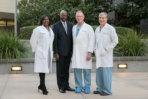From left, Luanda Grazette, Raymond Hall, Vaughn Starnes and Mark Barr gather Dec. 6 on the Health Sciences Campus. Nearly 18 years ago, Starnes and Barr performed a heart transplant on Hall; he continues to do well today under the care of Grazette.