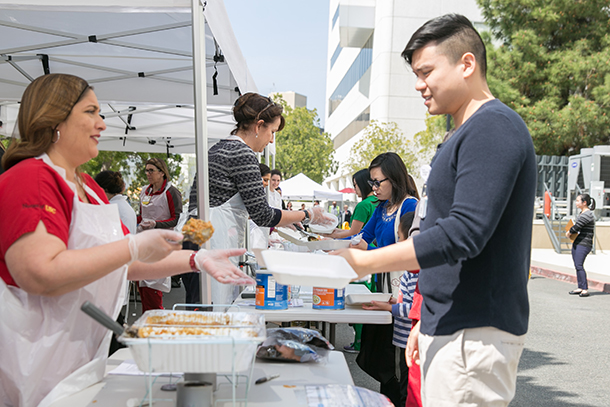 Volunteers serve meals during a mass feeding drill held on the Health Sciences Campus.