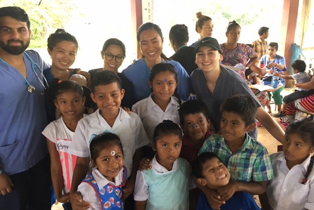 MS in Global Medicine students spend time with local children at the Floating Doctors clinic in Panama.
