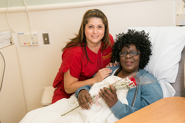 Lilia Lopez, RN, handed a rose to infusion patient Joyce Harris at the USC Norris Cancer Day Hospital in honor of Mother’s Day.