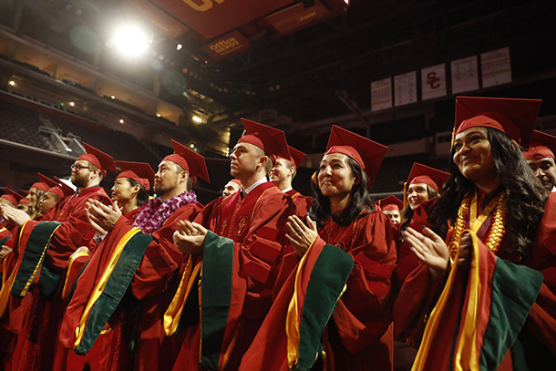 Doctor of Medicine candidates applaud during the commencement ceremony.