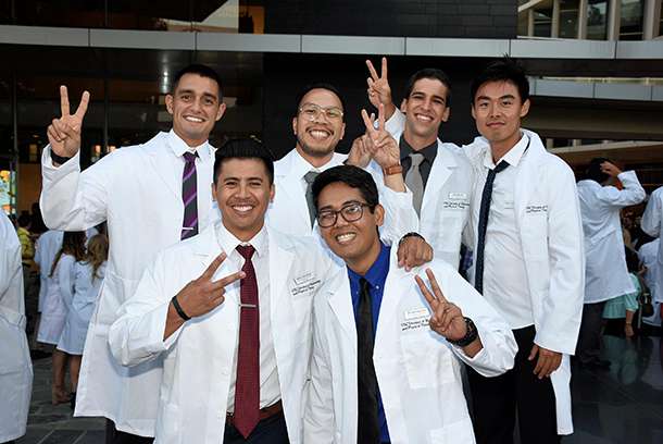 New students in the USC Division of Biokinesiology and Physical Therapy show Victory signs after a white coat ceremony on Aug. 23.