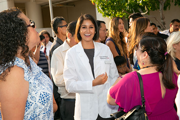 Marissa Valenzuela, center, smiles after the Keck School’s 2018 White Coat Ceremony on the Health Sciences Campus.