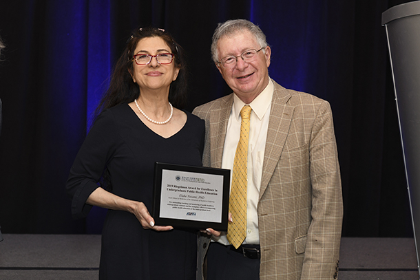 Elahe Nezami, left, is seen with Richard Riegelman, after being awarded the 2019 Riegelman Award for Excellence in Undergraduate Public Health Education.