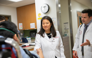 Tarina Kang and Stephen Sanko greet a patient