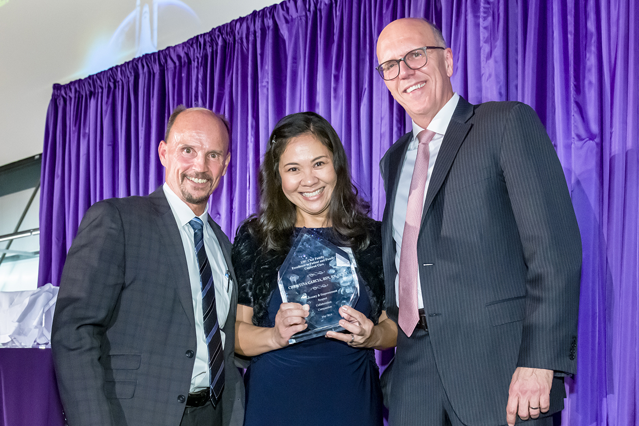Rod Hanners, left, and Tom Jackiewicz present Christina Garcia with the Choi Award for Excellence in Patient-Centered Care.