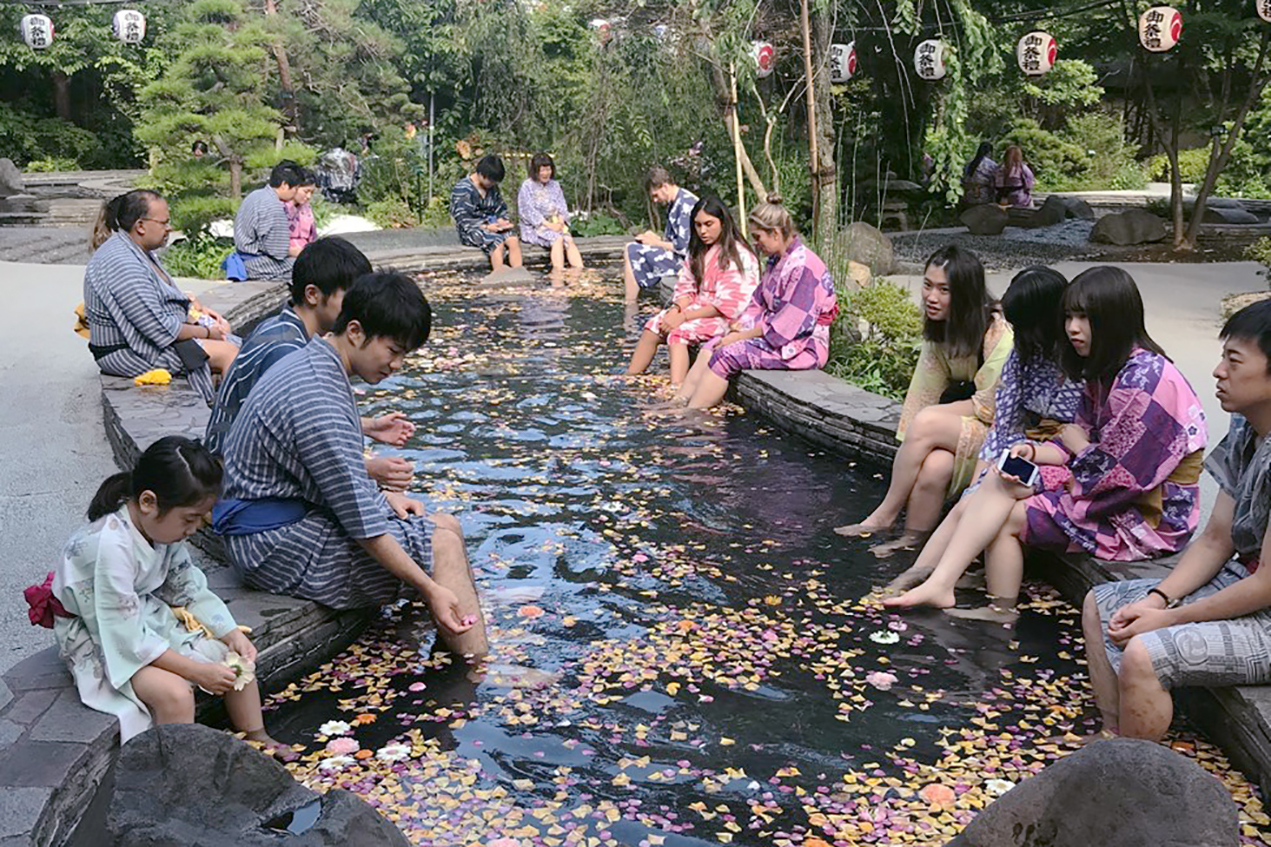 People bathe their feet at a Japanese ashiyu, a public bath for washing feet.
