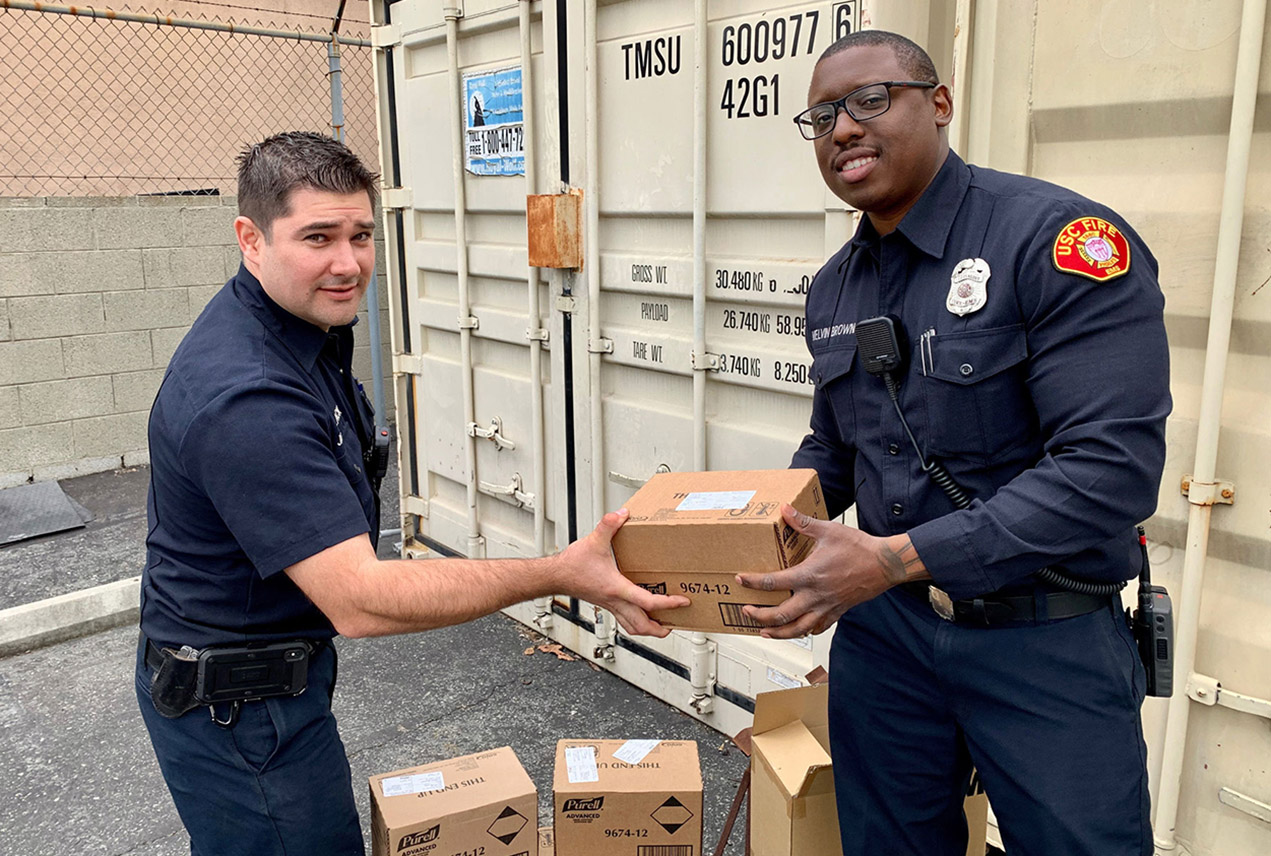 Fire safety specialists Jarrin Black, left, and Melvin Brown from USC Environmental Health & Safety prepare a donation of hand sanitizer to Keck Medicine of USC. 