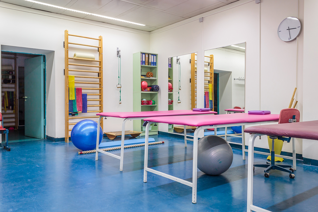 A room stands stocked with physical therapy equipment.