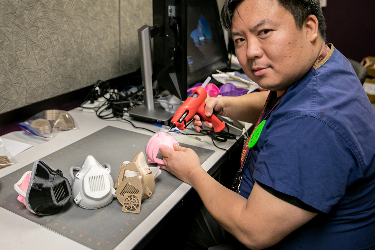 Darryl H. Hwang, PhD, demonstrates the step-by-step process to assemble one of the many face masks he's creating for the COVID-19 preparedness efforts at Keck Medicine of USC.