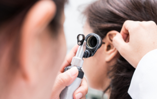 A doctor examines a patient's ear canal.