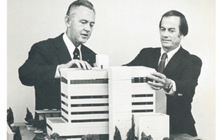 An old photo shows two men planning a hospital campus.
