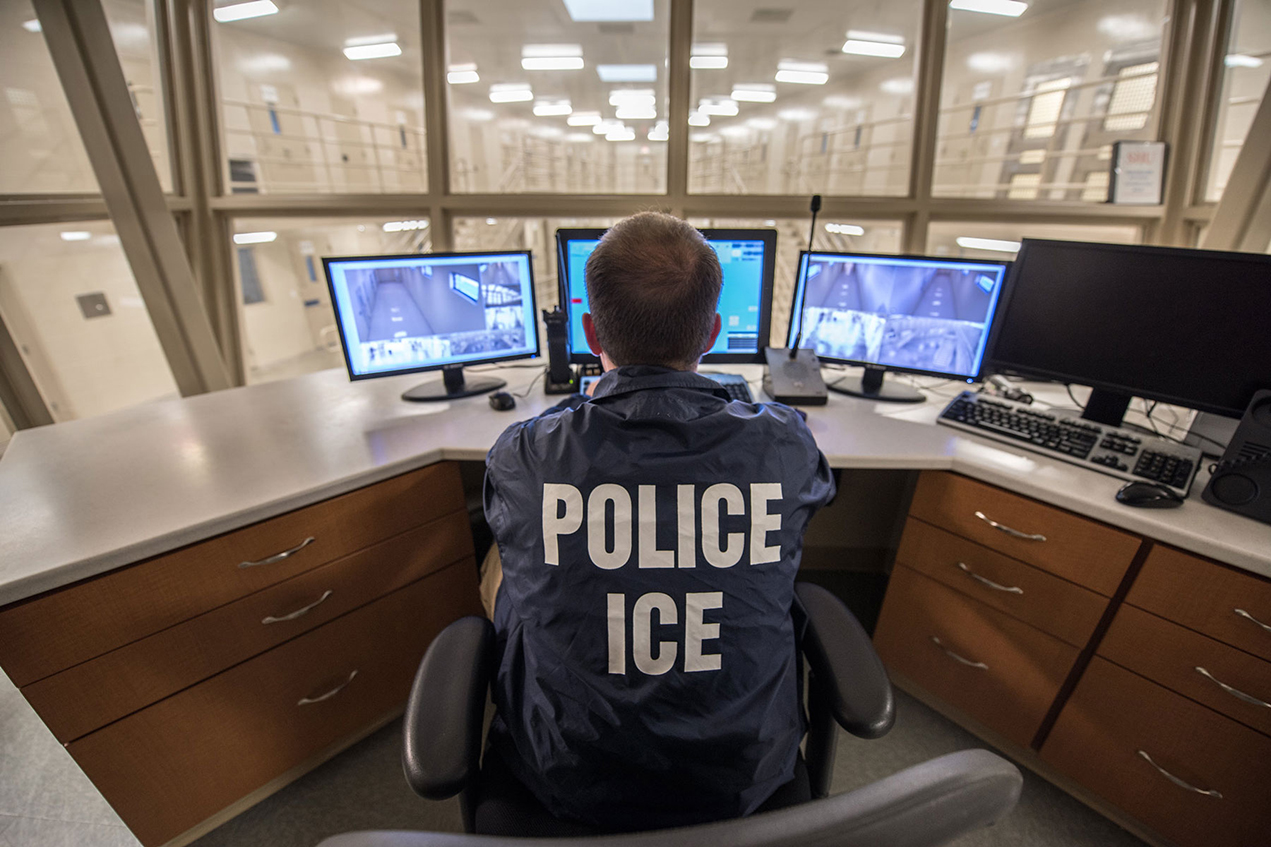 An ICE Enforcement and Removal Operations officer monitors a detention facility.
