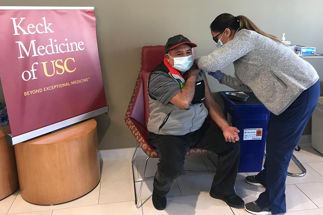 Sixto Cruz gets a COVID-19 vaccination during the Keck Medicine of USC clinic on Saturday.