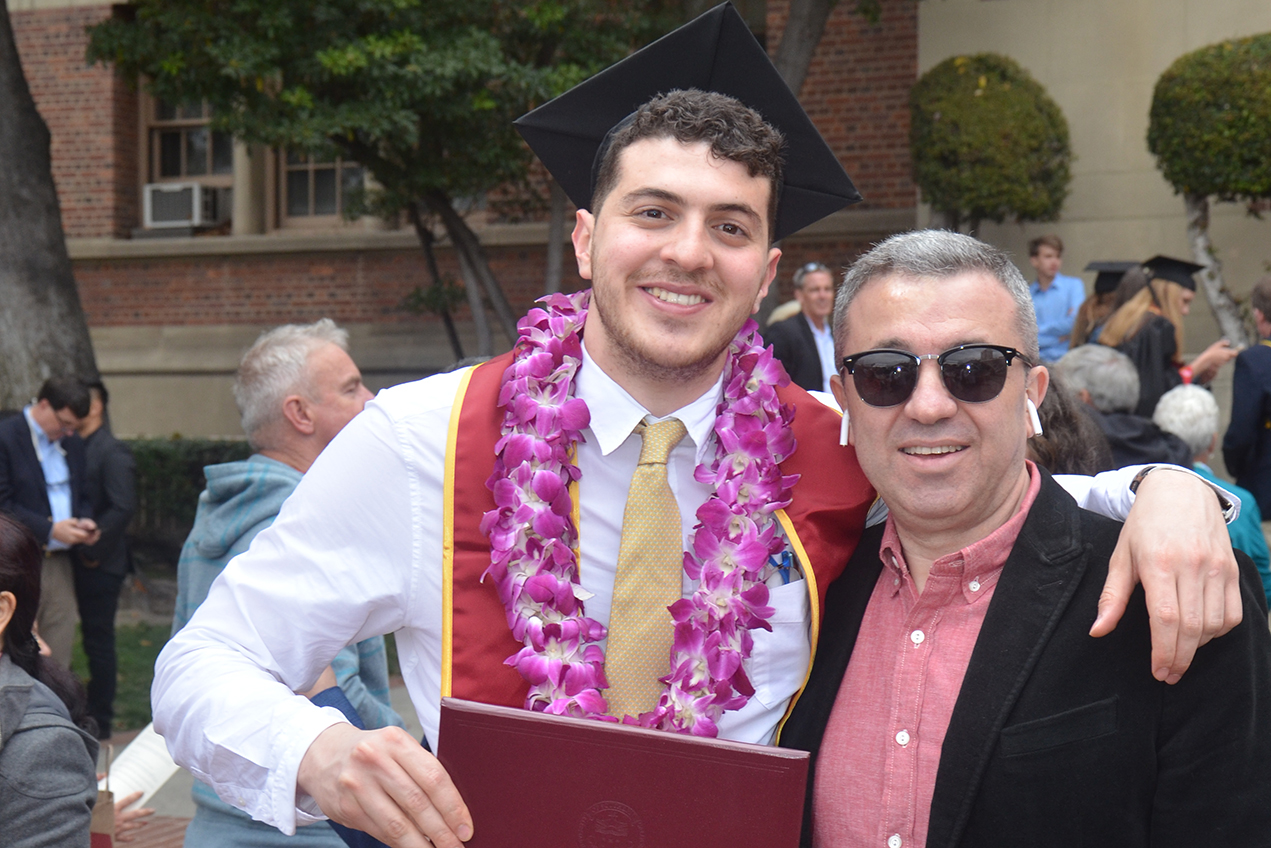 Eli Bosnoyan, left, poses with his father during his undergraduate commencement from USC in 2018.