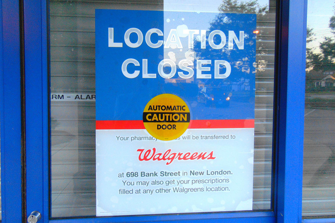 A Walgreens pharmacy door has a Location Closed sign