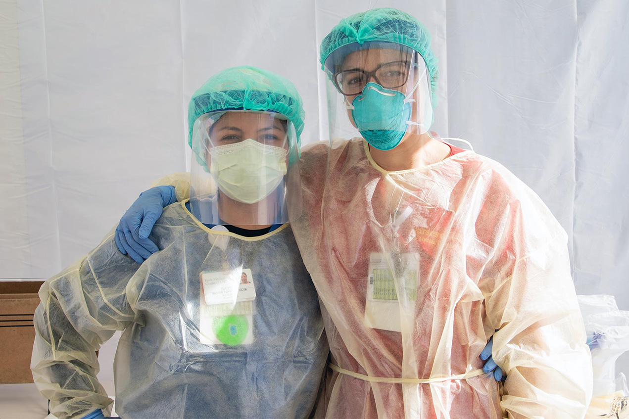Keck Medicine of USC nurses Sayuri Silva, left, and Claire Hoffman wear personal protective equipment during the pandemic.