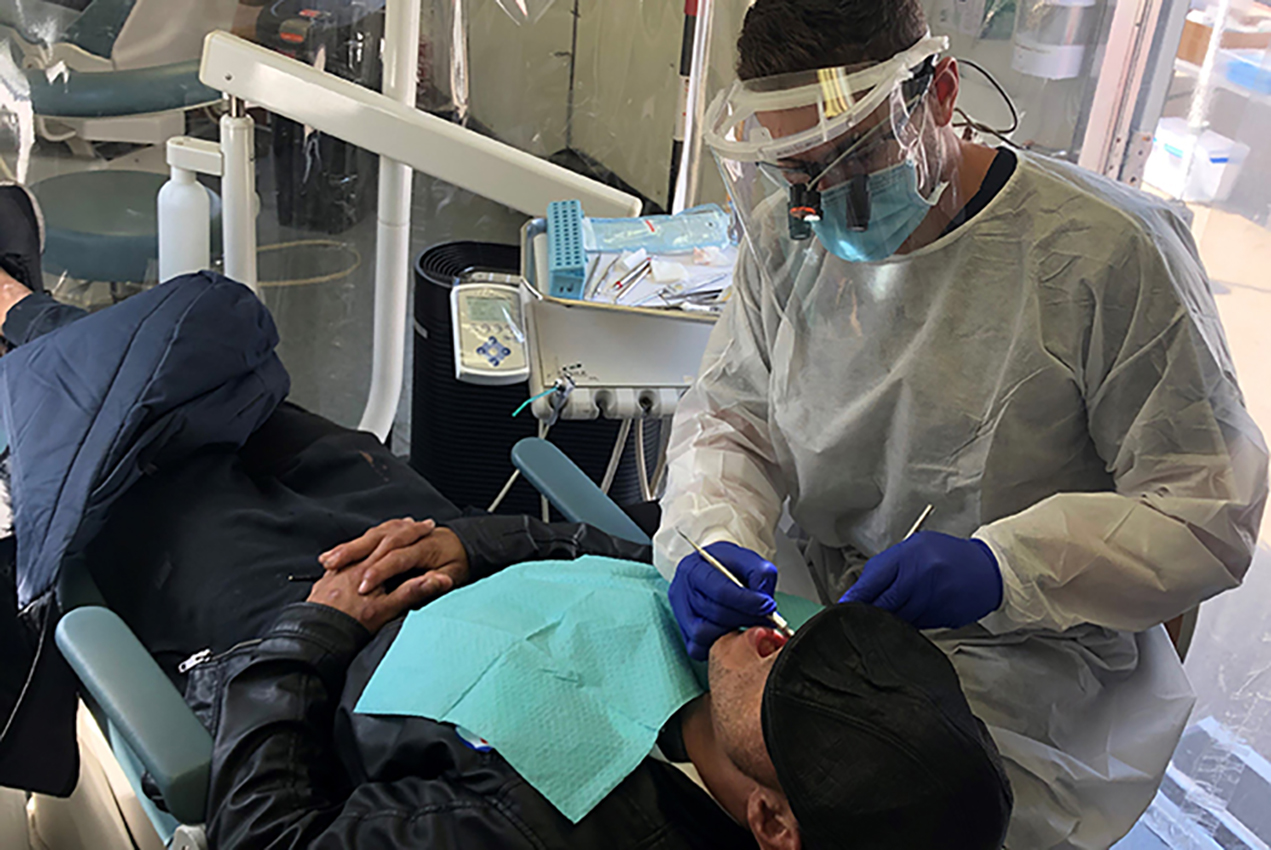 Dental student provides care to a veteran in the USC Mobile Dental Clinic.