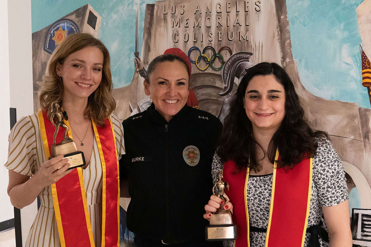 Riley McGuire, DPS Assistant Chief Alma Burke and Monica Caris pose after the two students were honored for their autism project.