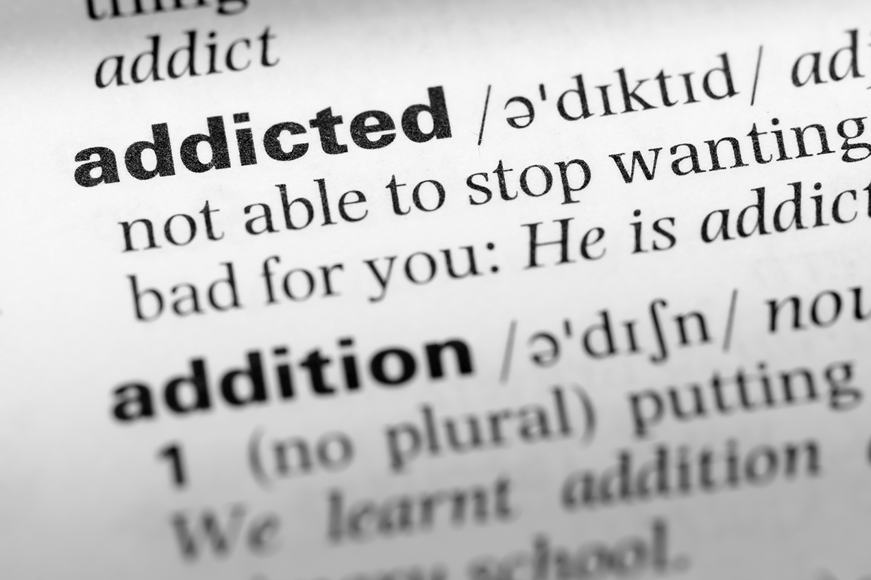 A dictionary entry defines the word addicted
