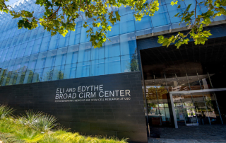 A sign in front of a building reads, Eli and Edythe Broad CIRM Center.