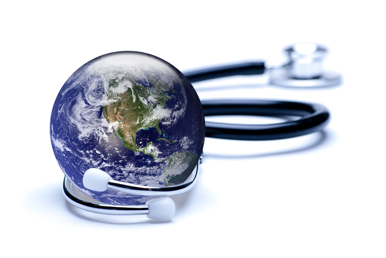 A stethoscope wraps around a realistic miniature of planet Earth