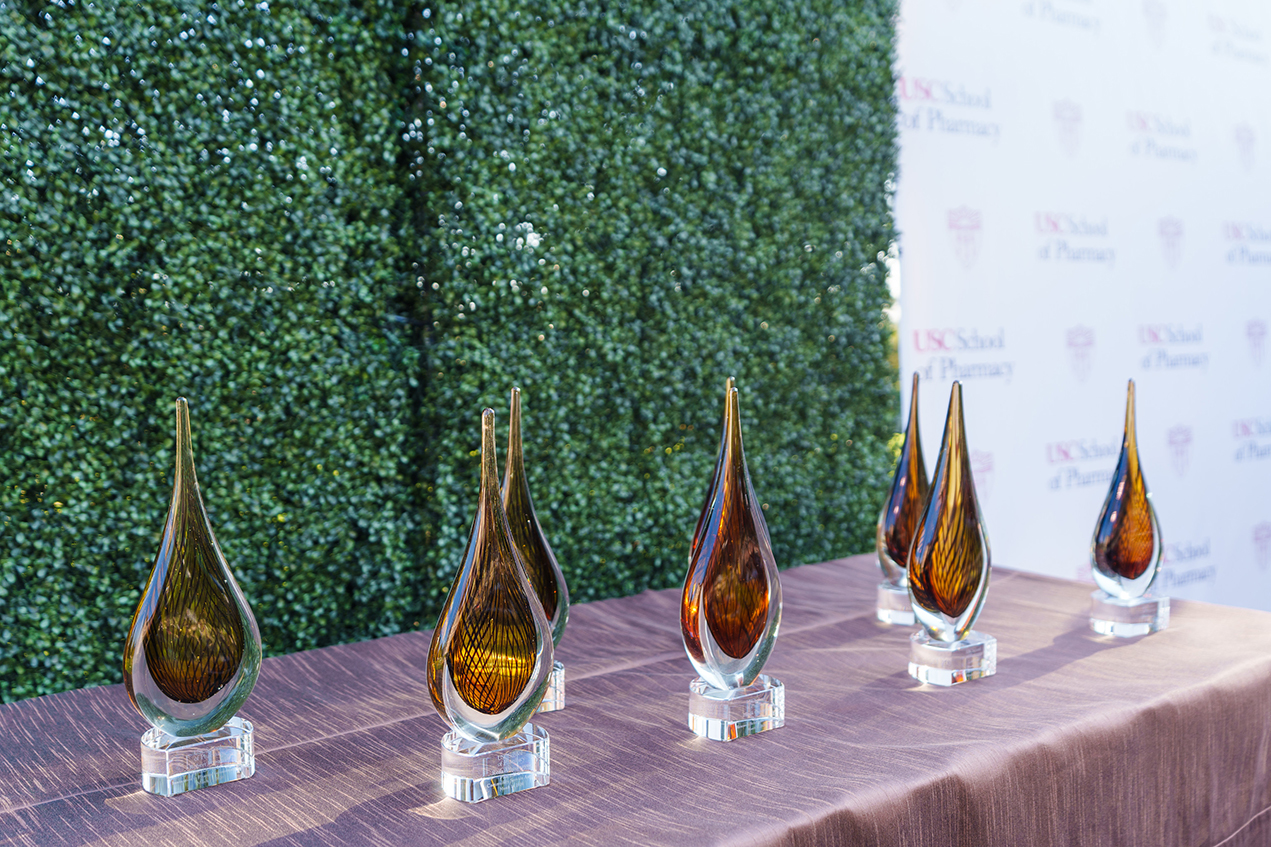 Sleek awards stand lined up on an outdoor table