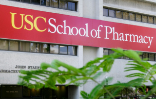 A banner outside a building reads, USC School of Pharmacy