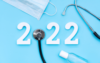 On a blue surface, medical supplies surround the number 2022