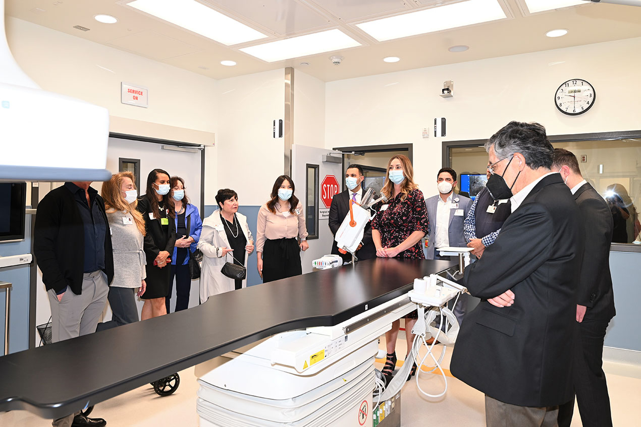 A group of people stand around a large piece of diagnostic equipment