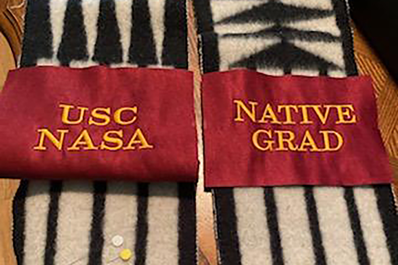 In addition to being presented with a sash, graduates shared legacies for future generations of Native American Trojans, including a scrapbook to which NASA students can continue to add their successes in the coming years.
