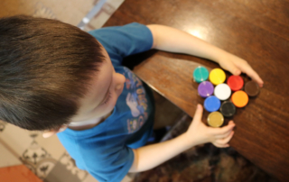 A small child plays with colorful blocks