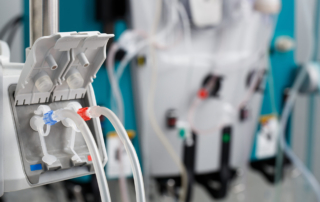 A close-up view focuses on the tubes of a dialysis machine