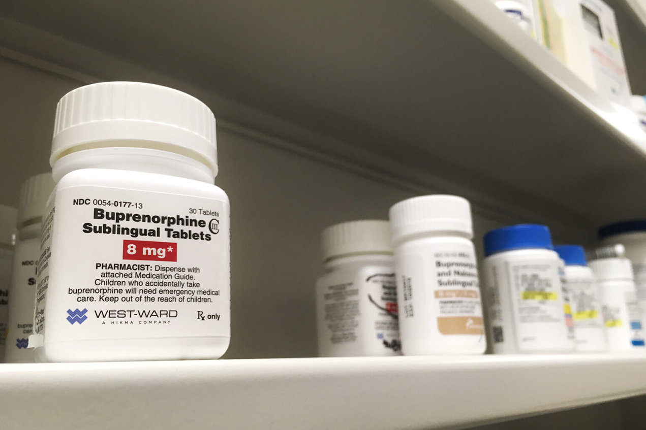 A bottle of buprenorphine stands out on a pharmacy shelf