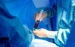 A surgeon's hands inject stem cells into a patient.