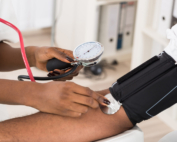 A doctor takes a patient's blood pressure