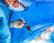 In surgery, a doctor injects modified blood into a patient.