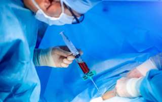 In surgery, a doctor injects modified blood into a patient.