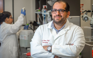 Josh Neman, PhD, scientific director of the USC Brain Tumor Center, poses with arms crossed in a laboratory