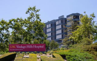 USC Verdugo Hills Hospital's facade with a sign and hospital building in the background