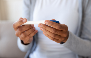 A woman's hands hold a pregnancy test