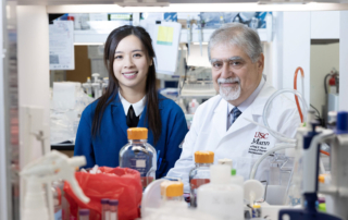 Yiqi Christina Lin, PhD, and USC Mann's Dean Vassilios Papadopoulos, DPharm, PhD, stand side-by-side in a lab