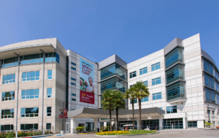USC Arcadia Hospital stands beneath a clear blue sky.